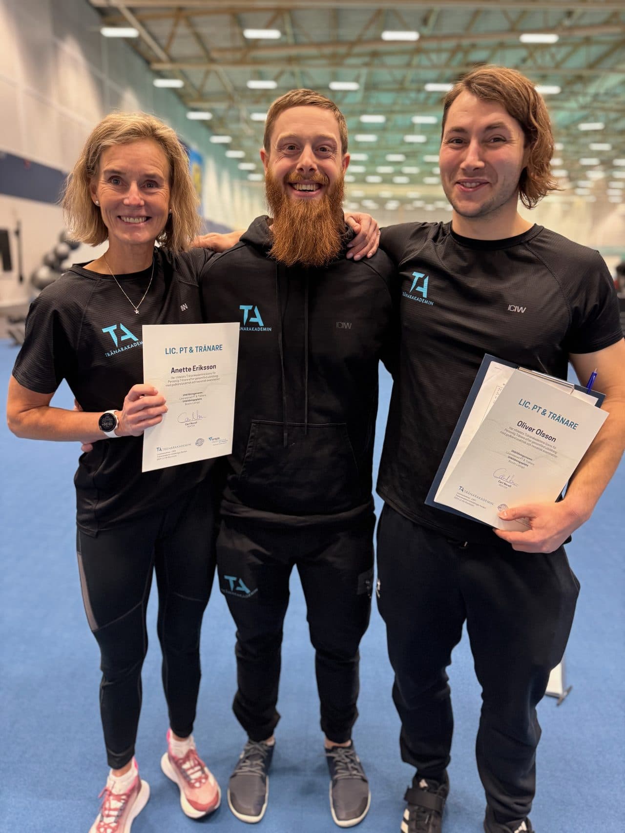Tre nyexaminerade studenter med licensbevis